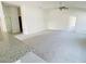Open living room with carpet, access to kitchen, and door leading to the outdoors at 4450 Sagefield Dr, Harmony, FL 34773