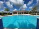 Community pool with a covered patio and palm trees at 4902 Chase Ct, St Cloud, FL 34772