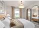 Primary bedroom with large windows and a stylish mirror at 5026 Starling Bird Ln, St Cloud, FL 34771