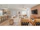 Living room with wood-look floors, neutral decor, and a wall-mounted TV at 5026 Starling Bird Ln, St Cloud, FL 34771