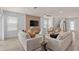 Open living room showcasing a cozy seating arrangement and large windows at 5026 Starling Bird Ln, St Cloud, FL 34771