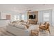Bright living room with comfy seating, stylish decor, and a large TV at 5026 Starling Bird Ln, St Cloud, FL 34771
