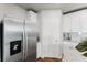 Stainless steel refrigerator in modern kitchen with white cabinets at 5252 Sanders Oak Trl, St Cloud, FL 34771