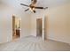 Bedroom with ceiling fan and access to bathroom and hallway at 6002 Tivoli Gardens Blvd, Orlando, FL 32829