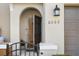 Close-up of townhome entrance with arched door and gate at 6002 Tivoli Gardens Blvd, Orlando, FL 32829