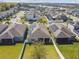 A beautiful aerial view showcases the community homes with solar panels and well-maintained lawns at 782 Grand Hilltop Dr, Apopka, FL 32703