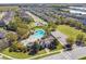 An aerial shot of the community with a pool, clubhouse, and playground amidst lush greenery at 782 Grand Hilltop Dr, Apopka, FL 32703
