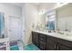 Bathroom with double sinks, vanity with drawers, and modern lighting at 782 Grand Hilltop Dr, Apopka, FL 32703