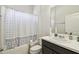 Bathroom featuring a shower-tub with a grey and white polka dot shower curtain at 782 Grand Hilltop Dr, Apopka, FL 32703