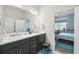 Clean bathroom featuring double sinks, a large mirror, and access to the main bedroom at 782 Grand Hilltop Dr, Apopka, FL 32703