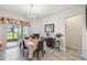 Bright dining room with modern chandelier, tile flooring, and sliding glass doors leading to the outdoor space at 782 Grand Hilltop Dr, Apopka, FL 32703