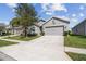 A well-maintained single Gathering home boasts a concrete driveway and a two car garage, with manicured landscaping at 782 Grand Hilltop Dr, Apopka, FL 32703