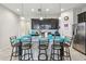 Spacious kitchen with a large island and seating, dark wood cabinets, stainless appliances, and granite countertops at 782 Grand Hilltop Dr, Apopka, FL 32703
