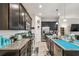 The kitchen features stainless steel appliances, granite countertops, dark cabinets, and a tiled floor at 782 Grand Hilltop Dr, Apopka, FL 32703