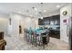 This spacious kitchen has dark cabinets, stainless steel appliances, a kitchen island, and ceramic tile flooring at 782 Grand Hilltop Dr, Apopka, FL 32703