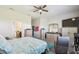 Bright main bedroom featuring carpet flooring, a ceiling fan, and a television at 782 Grand Hilltop Dr, Apopka, FL 32703