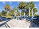 An inviting community pool area features palm trees and tables with umbrellas for relaxation at 782 Grand Hilltop Dr, Apopka, FL 32703