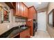 Laundry room with wood cabinets and granite countertop at 872 Edgeforest Ter, Sanford, FL 32771