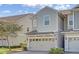 Townhome exterior with two-car garage and landscaping at 1008 E 10Th St, Apopka, FL 32703
