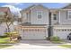 Townhome exterior featuring a two-car garage and charming facade at 1008 E 10Th St, Apopka, FL 32703