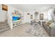 Bright living room with comfy gray sofa and large TV at 1008 E 10Th St, Apopka, FL 32703