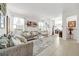 Open concept living area with gray sofa and view to dining area at 1008 E 10Th St, Apopka, FL 32703