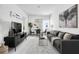 Modern living room with gray sectional sofa and black media console at 1008 E 10Th St, Apopka, FL 32703