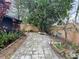 Spacious backyard featuring brick pavers, mature trees and foliage offering a private outdoor retreat at 1138 Easton St, Orlando, FL 32825