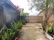 Backyard featuring brick pavers, mature trees and foliage offering a private outdoor retreat at 1138 Easton St, Orlando, FL 32825