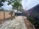 Backyard featuring brick pavers, mature trees and foliage offering a private outdoor retreat at 1138 Easton St, Orlando, FL 32825