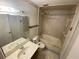Cozy bathroom features tub, vanity, mirror, and toilet with tile flooring and neutral walls at 1138 Easton St, Orlando, FL 32825