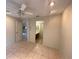 Neutral bedroom with tile floor, ceiling fan, and ensuite bathroom at 1138 Easton St, Orlando, FL 32825