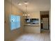 Well lit dining area boasts decorative chandelier and breakfast bar flowing into the kitchen at 1138 Easton St, Orlando, FL 32825