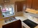 The kitchen features a stainless steel sink with wood cabinets and a view of the outside from a window at 1138 Easton St, Orlando, FL 32825