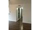Hallway with wood-look floors and access to kitchen and other rooms at 11568 Westwood Blvd # 1034, Orlando, FL 32821