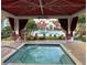 Relax in the hot tub located in the community pool area, near seating and landscaping at 11568 Westwood Blvd # 1034, Orlando, FL 32821