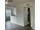 Living room with wood-look floors and view of kitchen at 11568 Westwood Blvd # 1034, Orlando, FL 32821