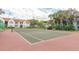 Community tennis court surrounded by lush landscaping at 11568 Westwood Blvd # 1034, Orlando, FL 32821