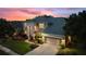 Two-story house with a three-car garage and manicured lawn at 13005 Islamorada Dr, Orlando, FL 32837