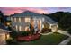 Two-story house with a three-car garage and manicured lawn at 13005 Islamorada Dr, Orlando, FL 32837
