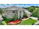 Two-story house with a landscaped yard and a large driveway at 13005 Islamorada Dr, Orlando, FL 32837