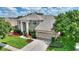 Two-story house with a three-car garage and manicured lawn at 13005 Islamorada Dr, Orlando, FL 32837