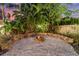 Relaxing backyard firepit area with stone seating and gravel flooring at 13005 Islamorada Dr, Orlando, FL 32837