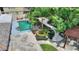 Elevated view of a backyard pool, pergola, and landscaping at 13005 Islamorada Dr, Orlando, FL 32837