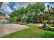 Landscaped backyard with a pergola and brick paver patio at 13005 Islamorada Dr, Orlando, FL 32837