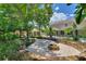 Fire pit in a landscaped backyard with a two-story house at 13005 Islamorada Dr, Orlando, FL 32837