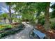 Landscaped backyard with benches and a stone pathway at 13005 Islamorada Dr, Orlando, FL 32837
