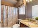 Bathroom with shower/tub combo, granite vanity and window at 13005 Islamorada Dr, Orlando, FL 32837