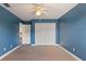 Blue bedroom with ceiling fan and double door closet at 13005 Islamorada Dr, Orlando, FL 32837