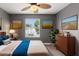 Bedroom with ceiling fan, dresser, and window with view at 13005 Islamorada Dr, Orlando, FL 32837